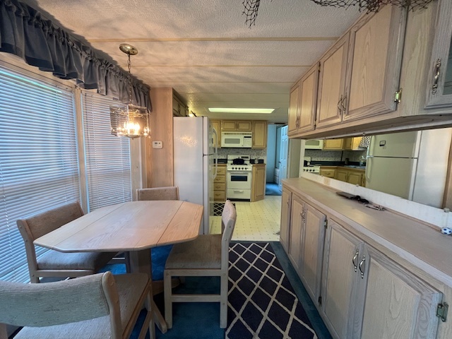 2795 East 28th Road Marseilles, IL 61341 - Photo 11 of 57 a kitchen with a dining table chairs and refrigerator