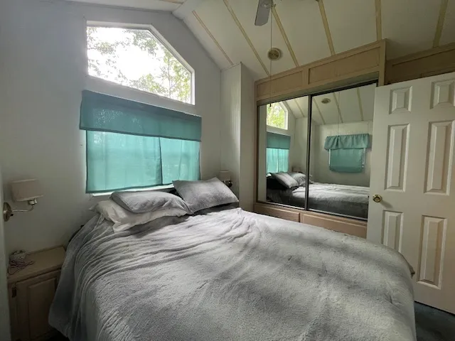 a bedroom with a large bed and a large window