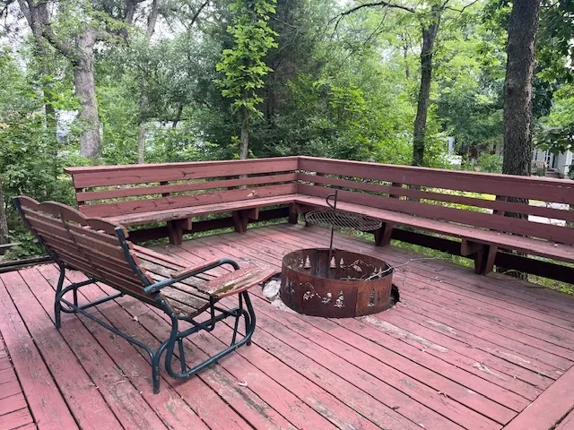 a view of a patio with dining table and chairs with wooden floor