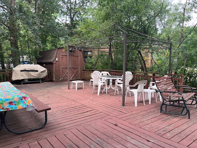2795 East 28th Road Marseilles, IL 61341 - Photo 17 of 57 a view of a patio with dining table and chairs with wooden floor