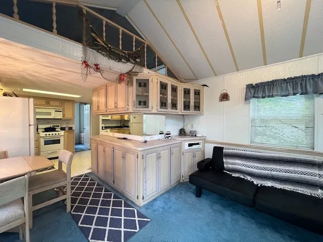 a kitchen with kitchen island granite countertop lots of counter top space and stainless steel appliances