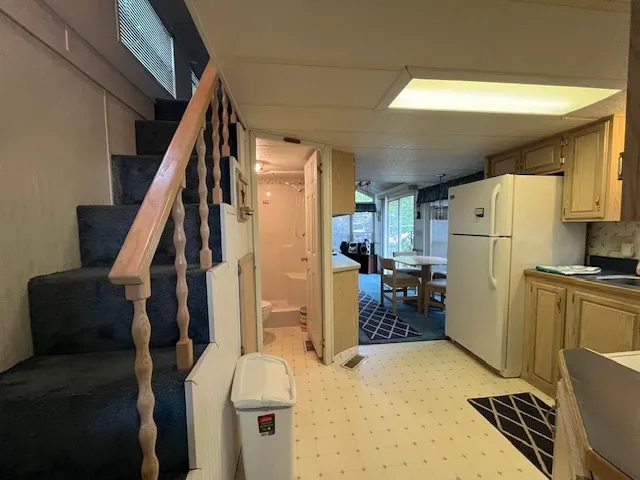 a living room with a couch and a refrigerator