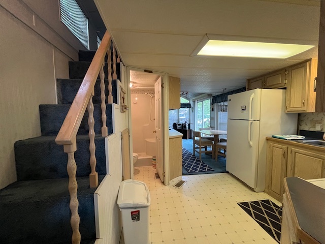 2795 East 28th Road Marseilles, IL 61341 - Photo 7 of 57 a living room with a couch and a refrigerator