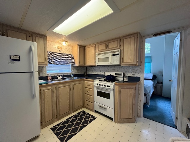 2795 East 28th Road Marseilles, IL 61341 - Photo 9 of 57 a kitchen with stainless steel appliances granite countertop a stove a sink and a refrigerator