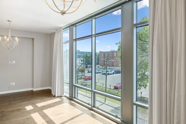 a view of a room that has a bed and a window