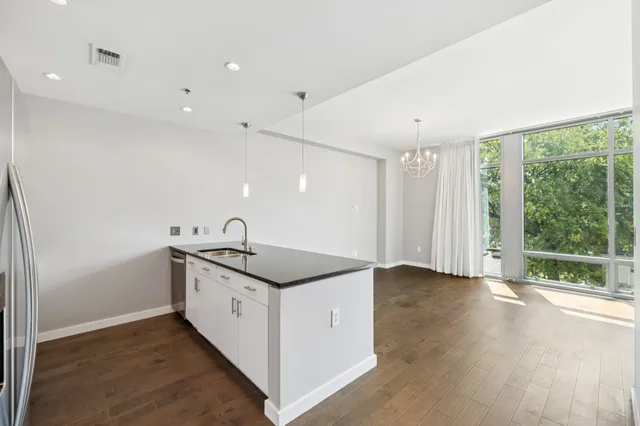 a spacious bathroom with a granite countertop sink and a window