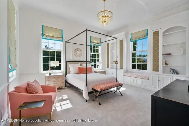 a spacious bedroom with a bed couch and window