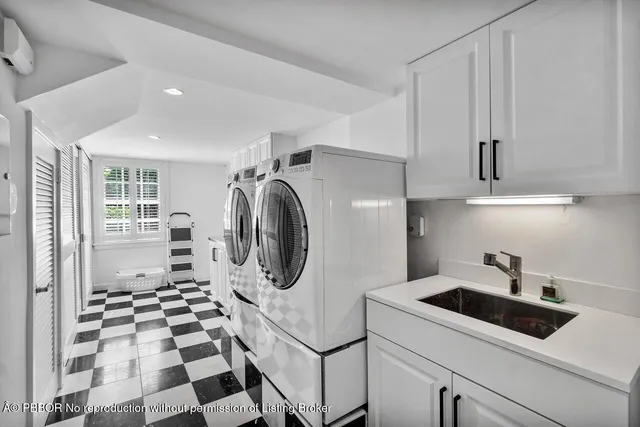 a utility room with sink dryer and washer