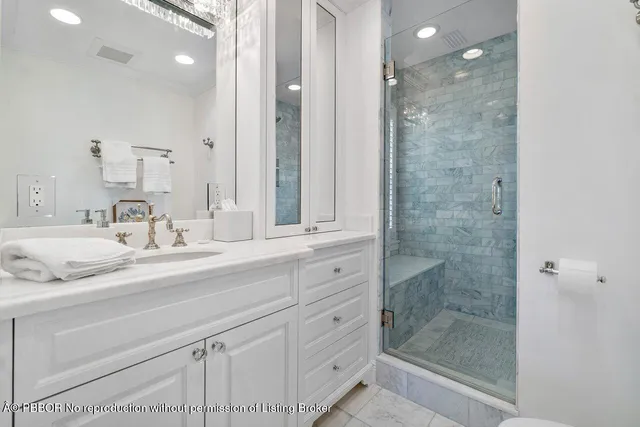 a bathroom with a shower sink and mirror
