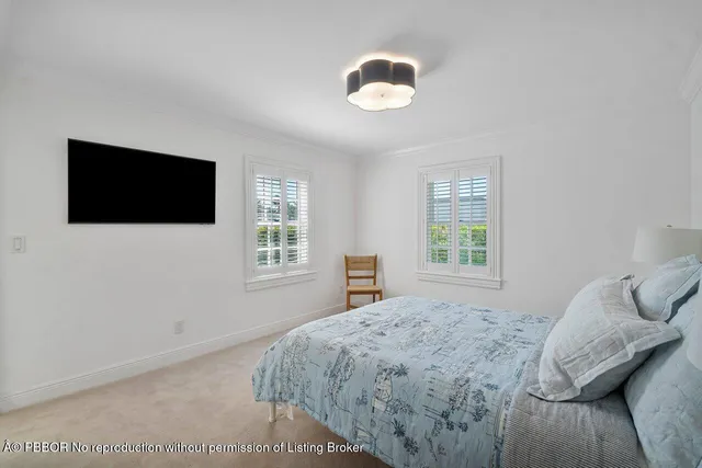 a bedroom with a large bed and a flat screen tv