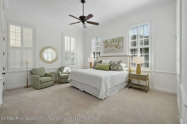 a bedroom with a bed a chandelier and a window