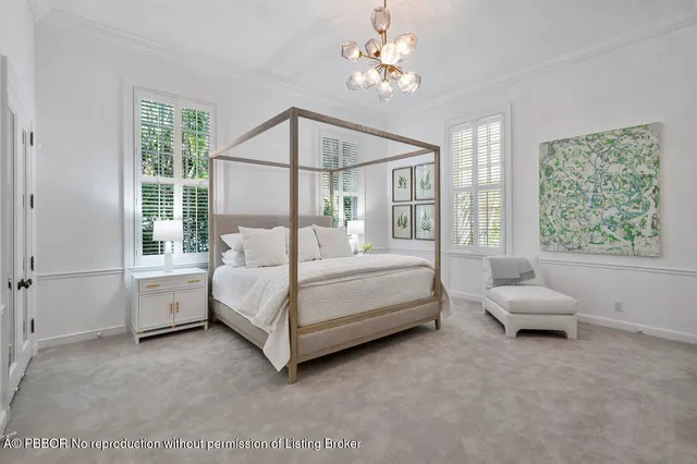 a bedroom with a white bed couch and window