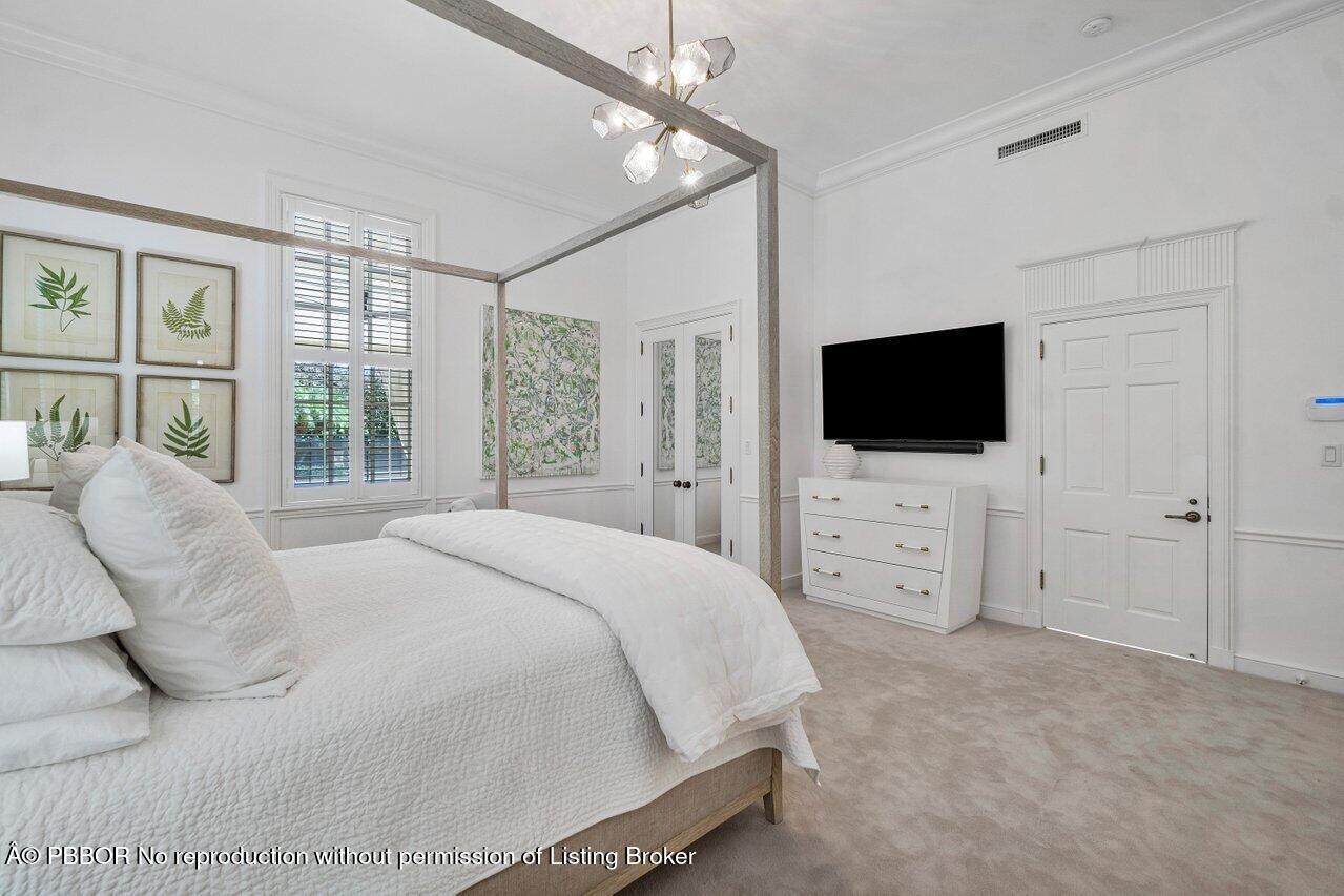 100 Regents Park Road Palm Beach, FL 33480 - Photo 29 of 42 a bedroom with a bed tv and window