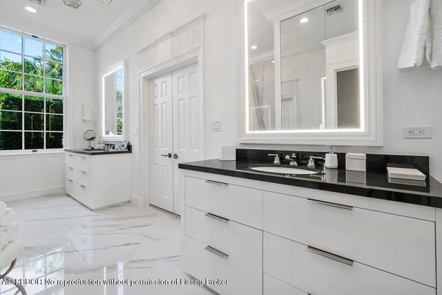 a bathroom with a sink a mirror and a bathtub