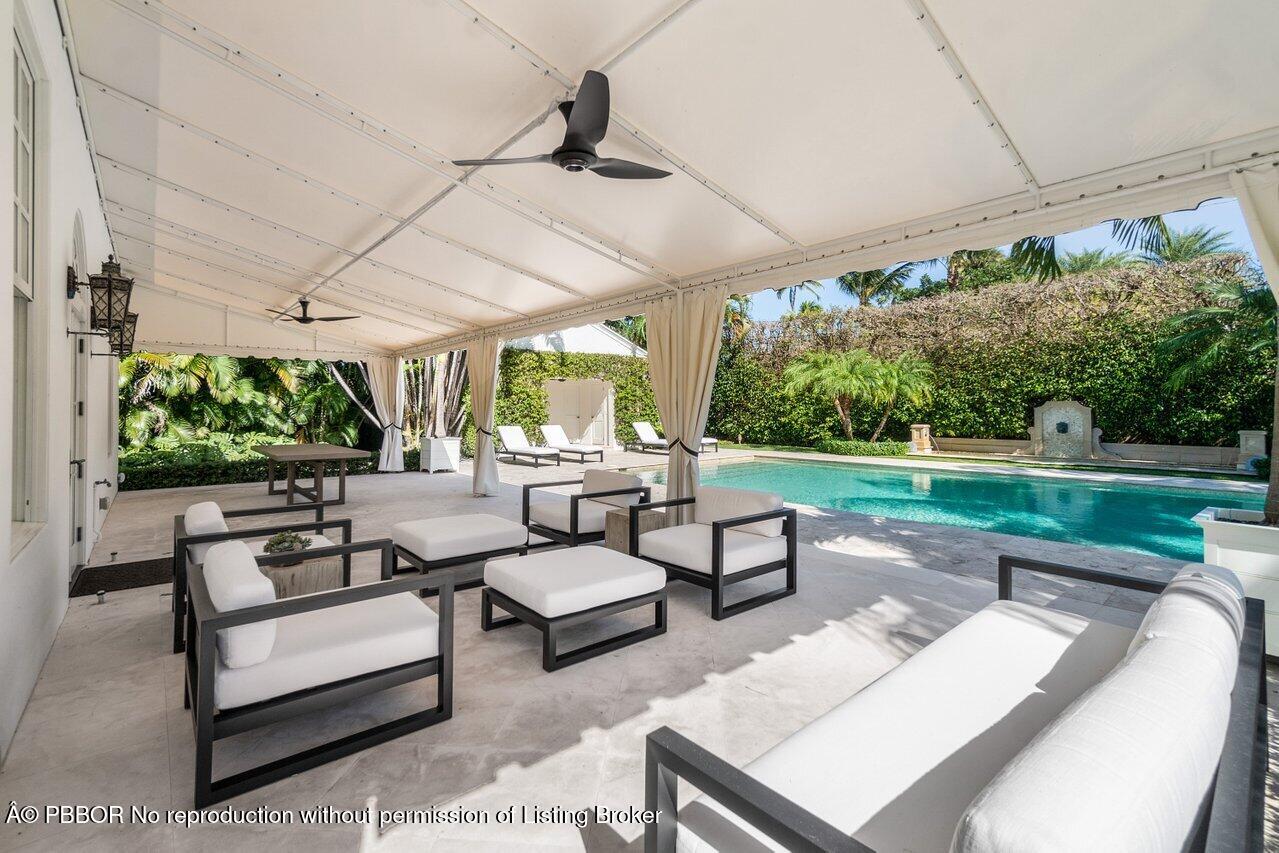 100 Regents Park Road Palm Beach, FL 33480 - Photo 32 of 42 a outdoor living space with patio furniture and a garden