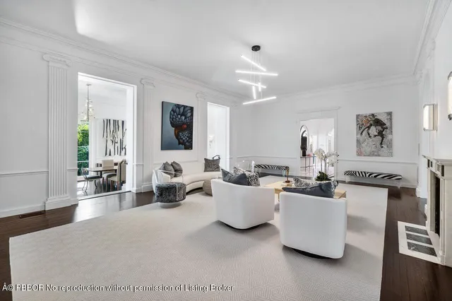 a living room with furniture a flat screen tv and a large window