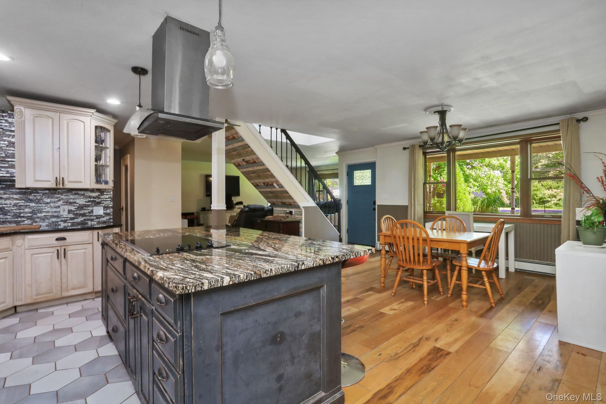 487 Chestnut Ridge Road Dover Plains, NY 12522 - Photo 14 of 41 a kitchen with stainless steel appliances granite countertop a stove a refrigerator a kitchen island a dining table and chairs with wooden floor