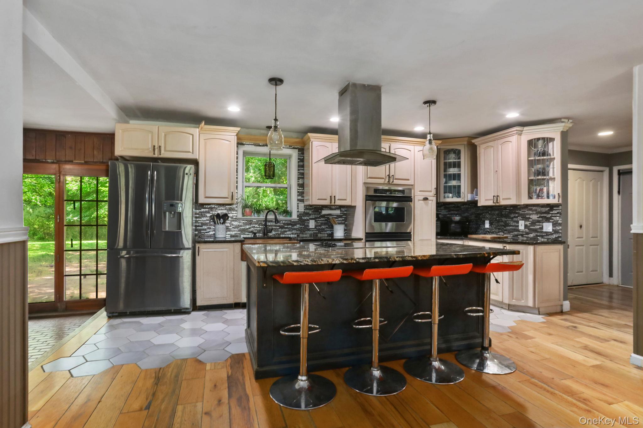 487 Chestnut Ridge Road Dover Plains, NY 12522 - Photo 16 of 41 a kitchen with stainless steel appliances a dining table chairs stove and refrigerator