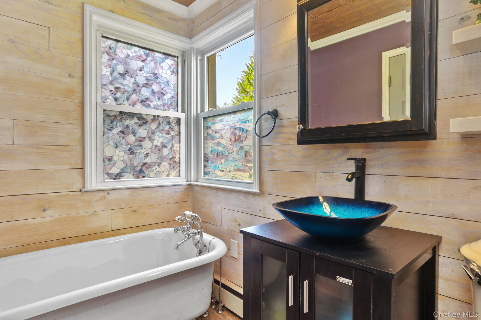 487 Chestnut Ridge Road Dover Plains, NY 12522 - Photo 19 of 41 a bathroom with a bathtub sink and mirror