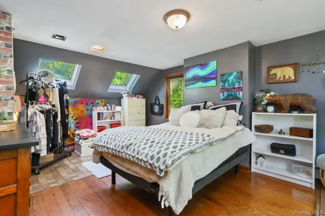 a bed sitting in a bedroom next to a large window