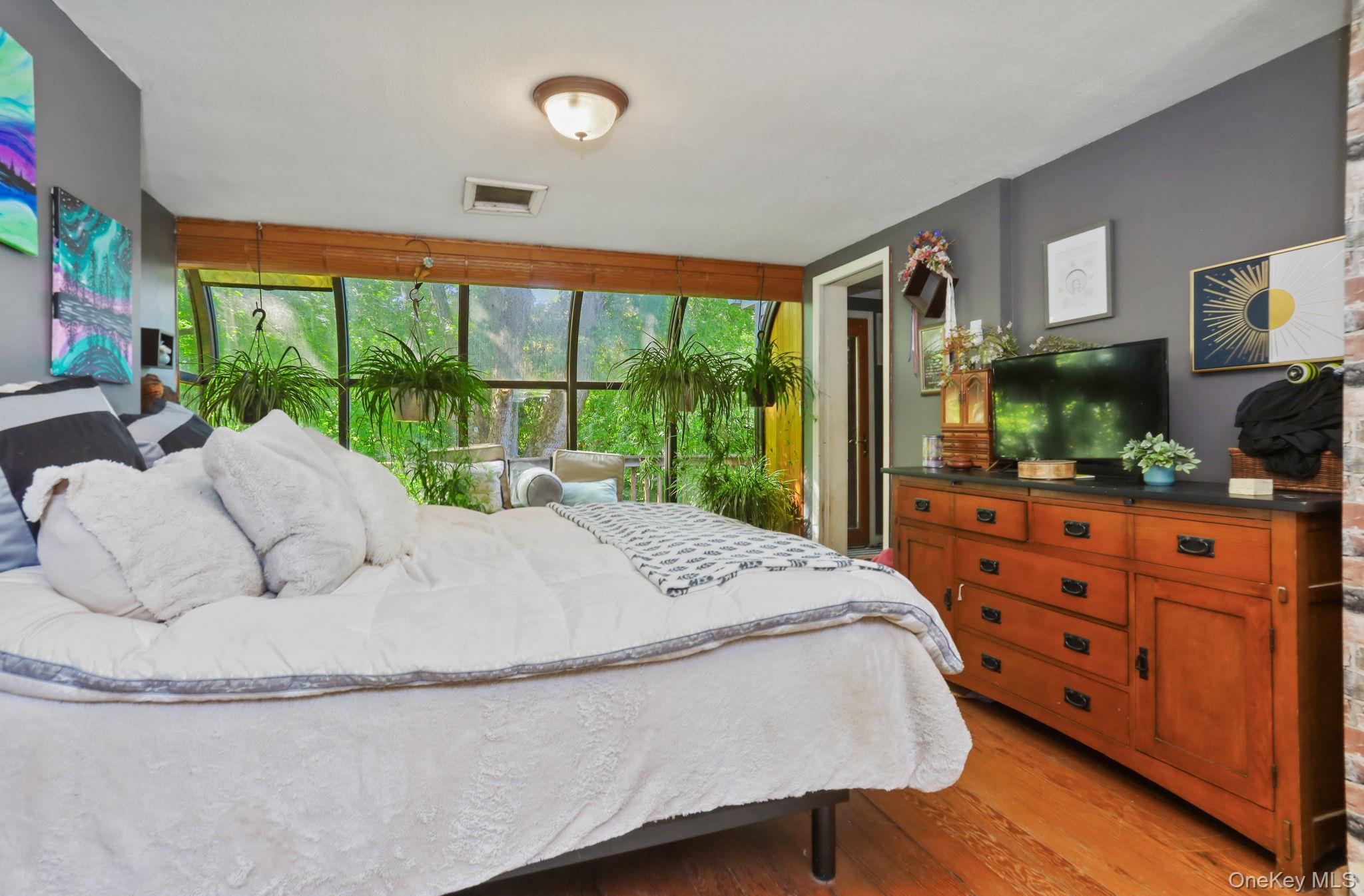 487 Chestnut Ridge Road Dover Plains, NY 12522 - Photo 28 of 41 a bed sitting in a bedroom next to a large window