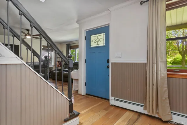 a view of entryway with stairs and wooden floor