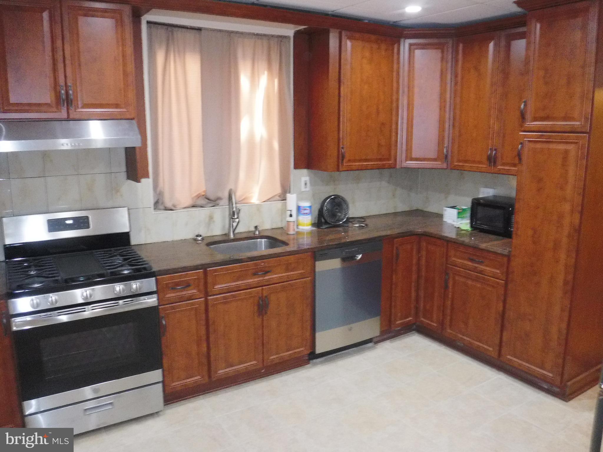 540 George Street Norristown, PA 19401 - Photo 19 of 53 a kitchen with stainless steel appliances granite countertop a stove a sink and a microwave