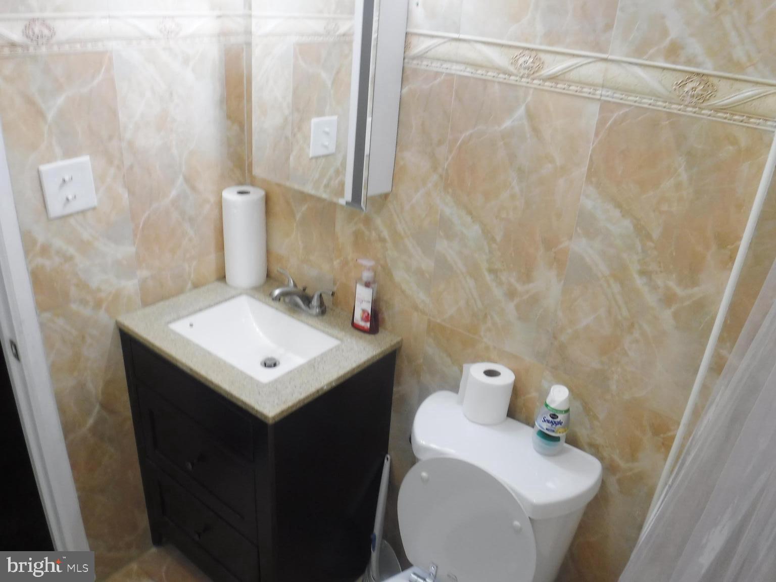 540 George Street Norristown, PA 19401 - Photo 31 of 53 a bathroom with a sink a toilet and a mirror