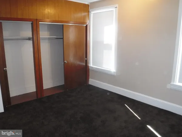an empty room with wooden floor