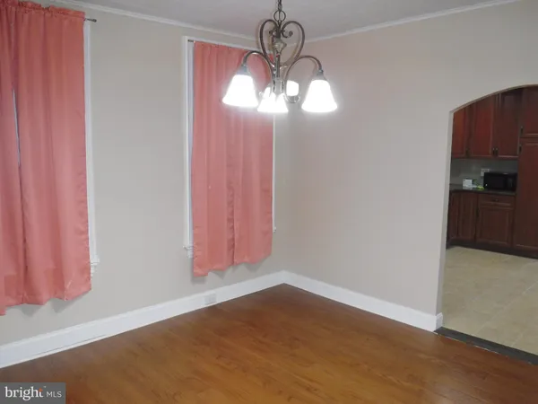 a view of a chandelier fan and hardwood floor