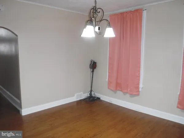 a view of a chandelier fan and fire place