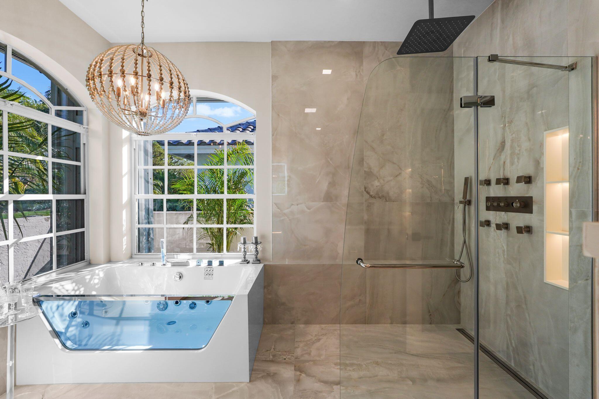 7686 La Corniche Circle Boca Raton, FL 33433 - Photo 20 of 35 a bathroom with a tub a window and a shower