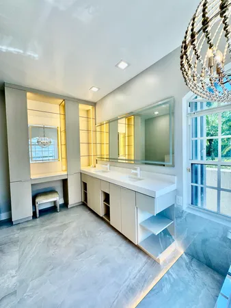 a spacious bathroom with double vanity and a shower