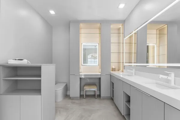 a bathroom with a granite countertop shower a toilet and a sink