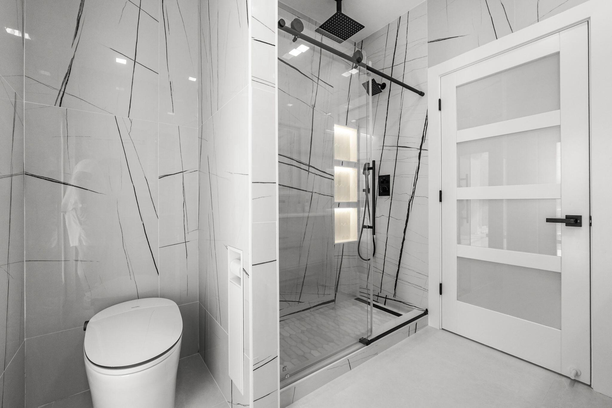 7686 La Corniche Circle Boca Raton, FL 33433 - Photo 28 of 35 a bathroom with a granite countertop shower a toilet and a sink