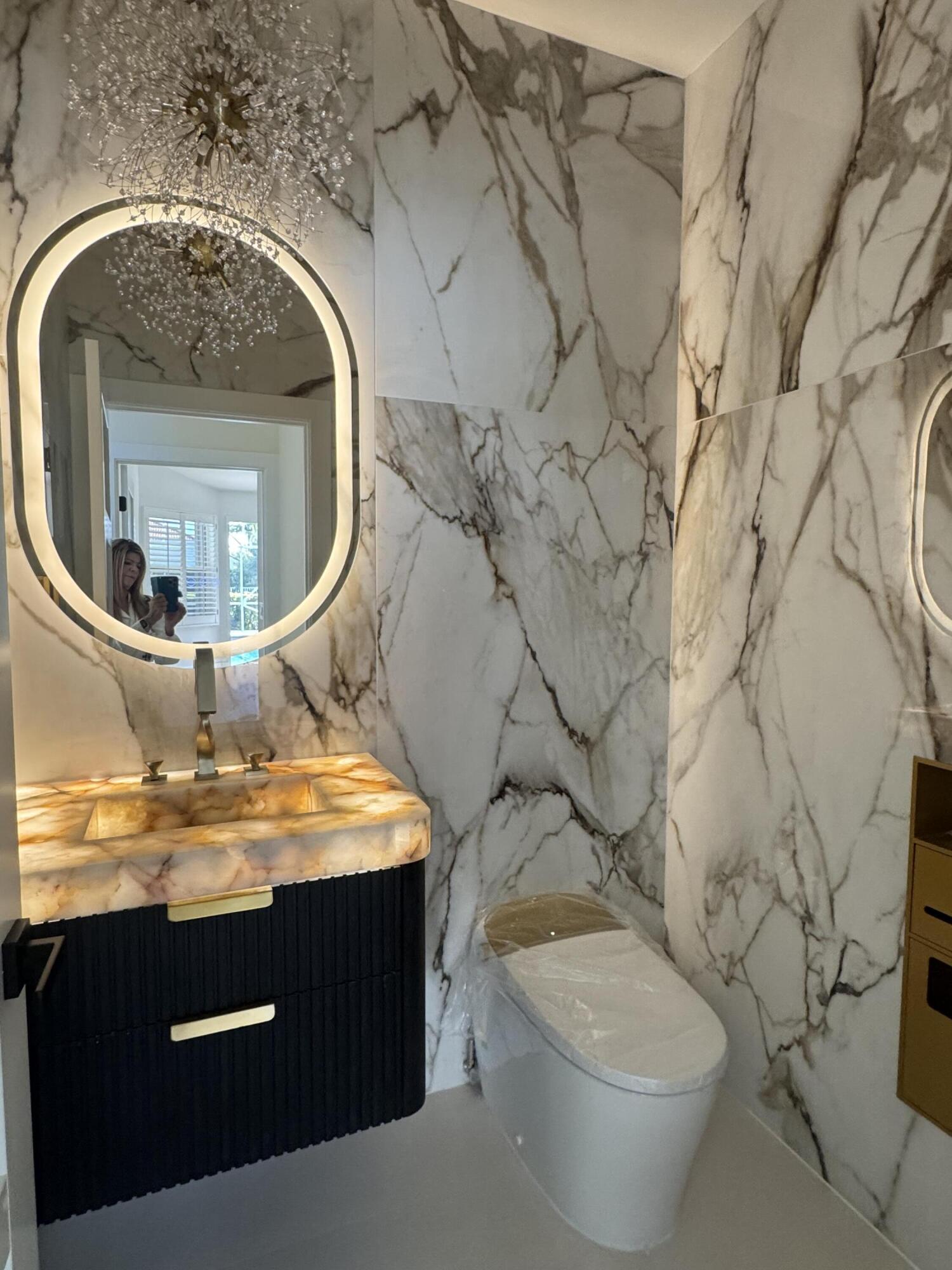 7686 La Corniche Circle Boca Raton, FL 33433 - Photo 29 of 35 a view of a bathroom with a granite countertop toilet and a sink