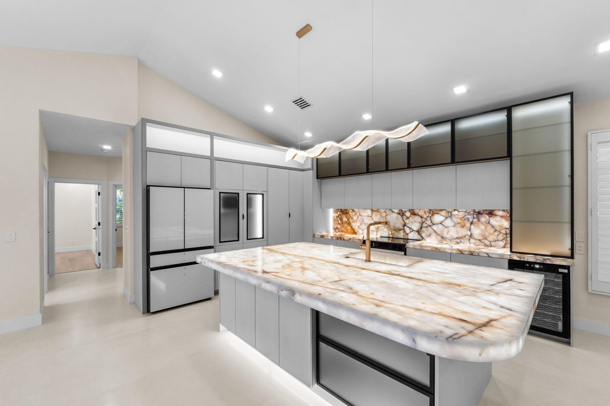 7686 La Corniche Circle Boca Raton, FL 33433 - Photo 5 of 35 a kitchen with kitchen island granite countertop a oven and a refrigerator