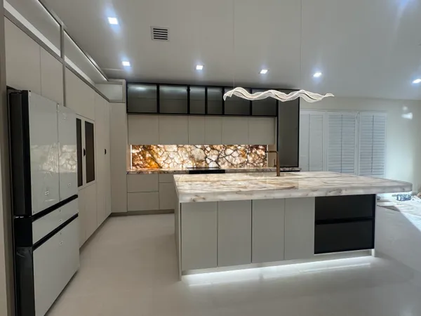 a kitchen with granite countertop white cabinets and white appliances