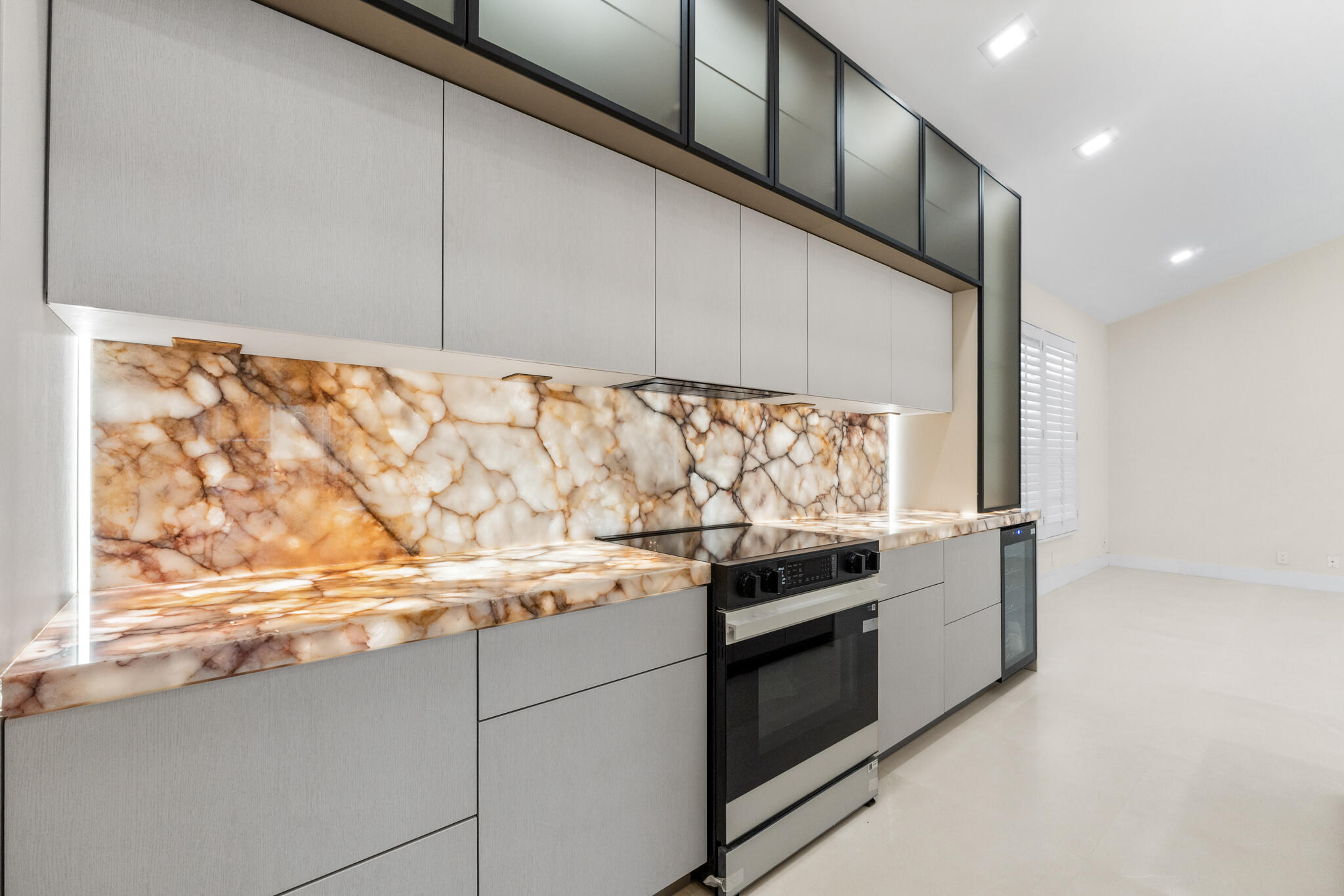 7686 La Corniche Circle Boca Raton, FL 33433 - Photo 7 of 35 a kitchen with granite countertop white cabinets and white appliances