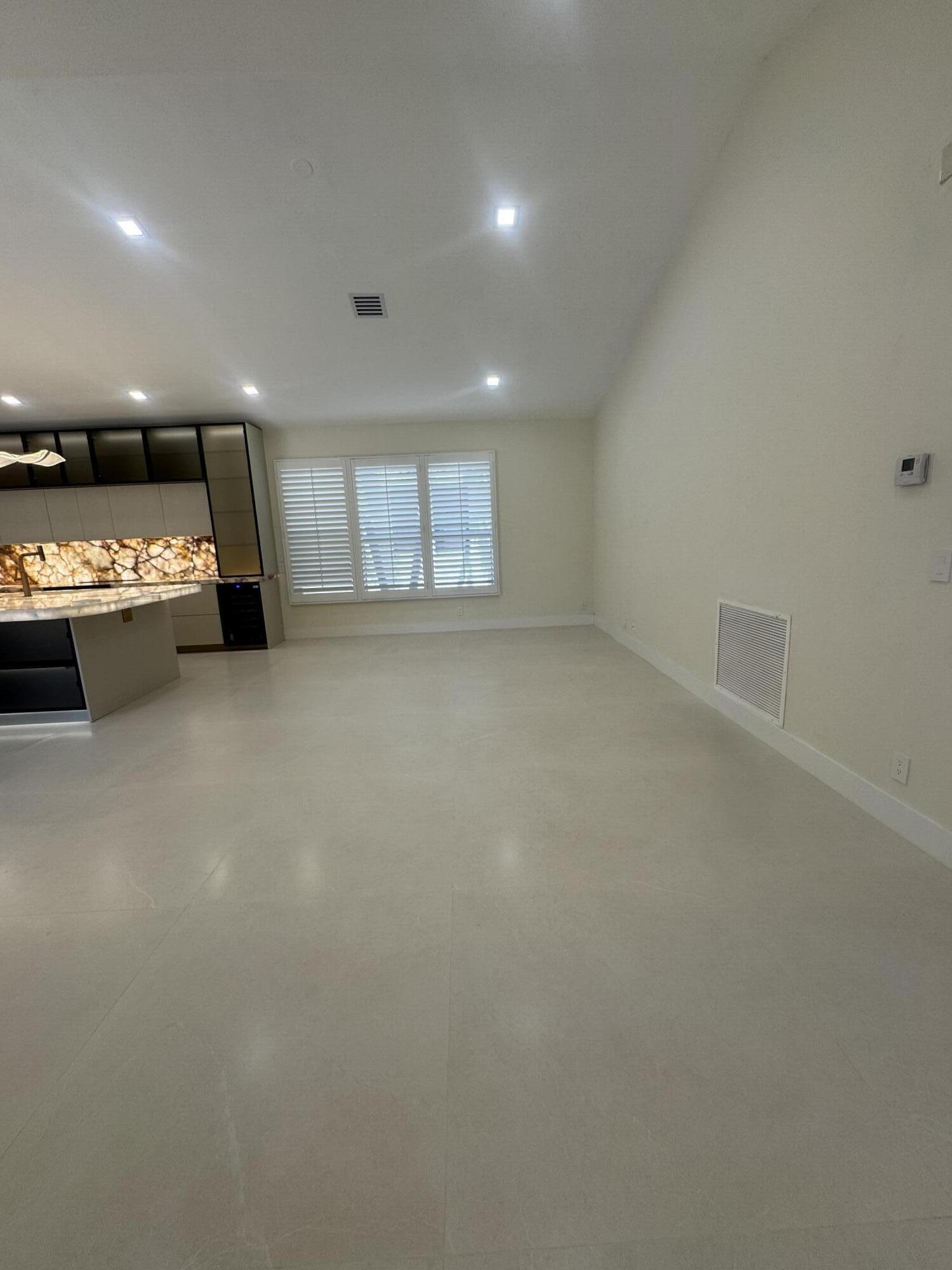 7686 La Corniche Circle Boca Raton, FL 33433 - Photo 10 of 35 an empty room with windows