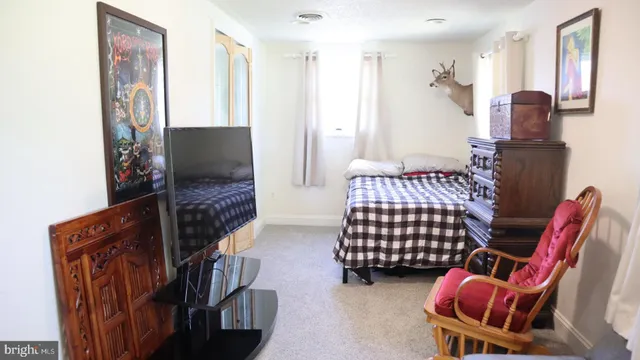 a bedroom with furniture and a flat screen tv