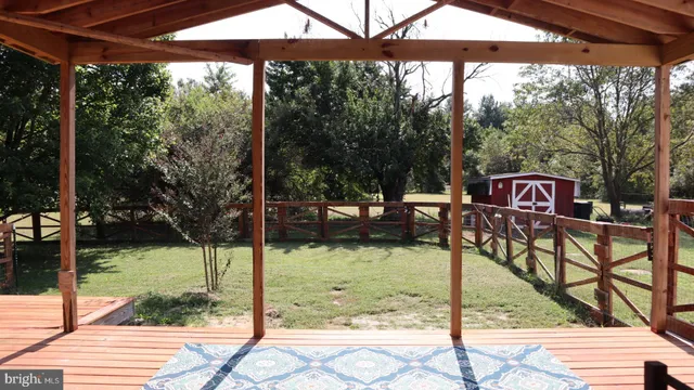 a view of a patio with a table chairs and a backyard