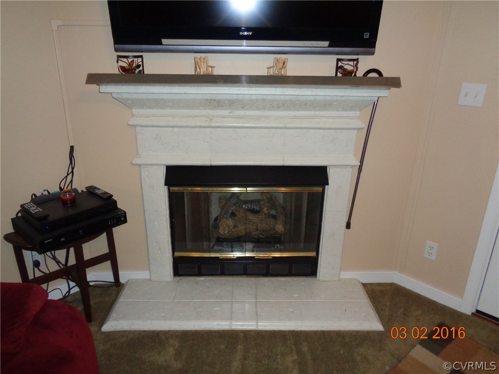 8612 Old Pine Road Ford, VA 23850 - Photo 12 of 27 a living room with furniture and a fireplace