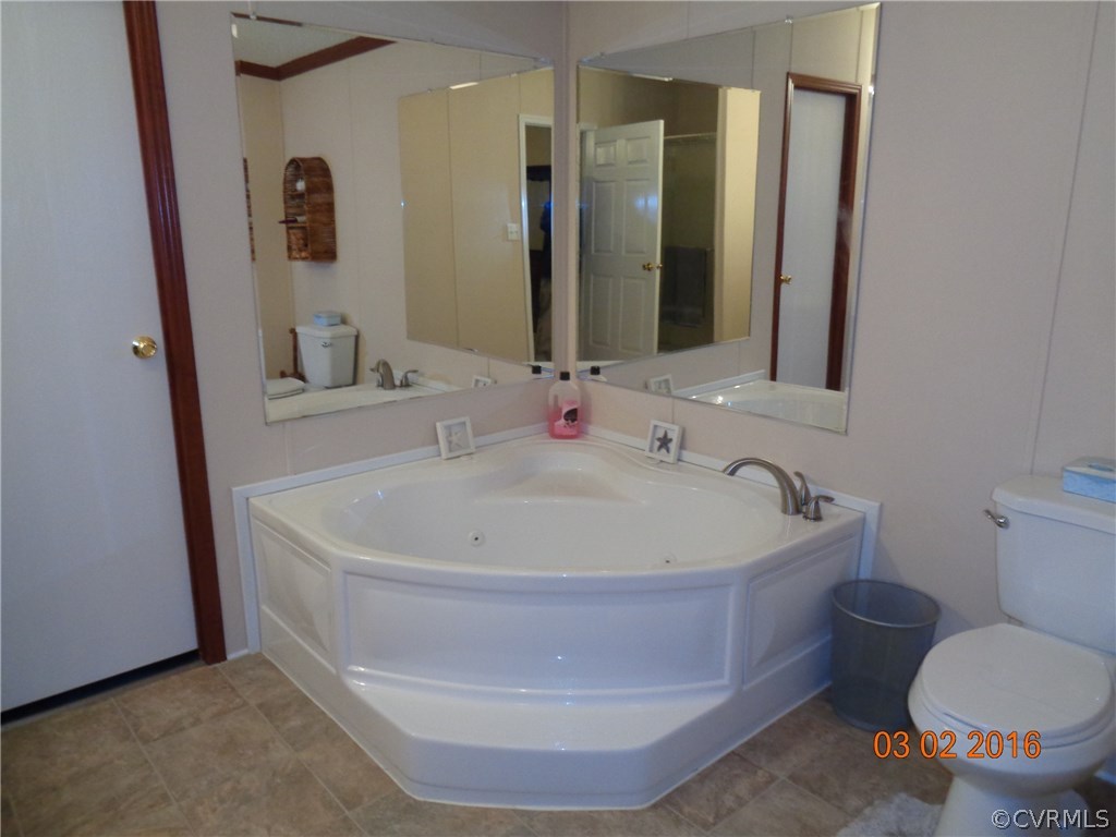 8612 Old Pine Road Ford, VA 23850 - Photo 14 of 27 a white bath tub sitting next to a white toilet