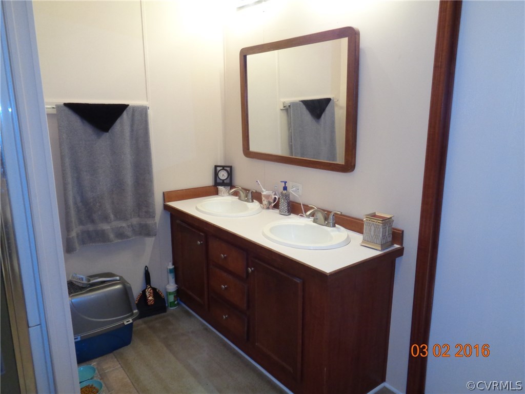 8612 Old Pine Road Ford, VA 23850 - Photo 15 of 27 a bathroom with a sink vanity and a mirror
