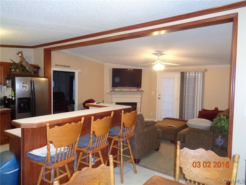 8612 Old Pine Road Ford, VA 23850 - Photo 17 of 27 a living room with stainless steel appliances furniture a fireplace and a flat screen tv