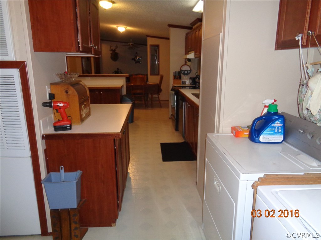 8612 Old Pine Road Ford, VA 23850 - Photo 22 of 27 a kitchen with a refrigerator and a table