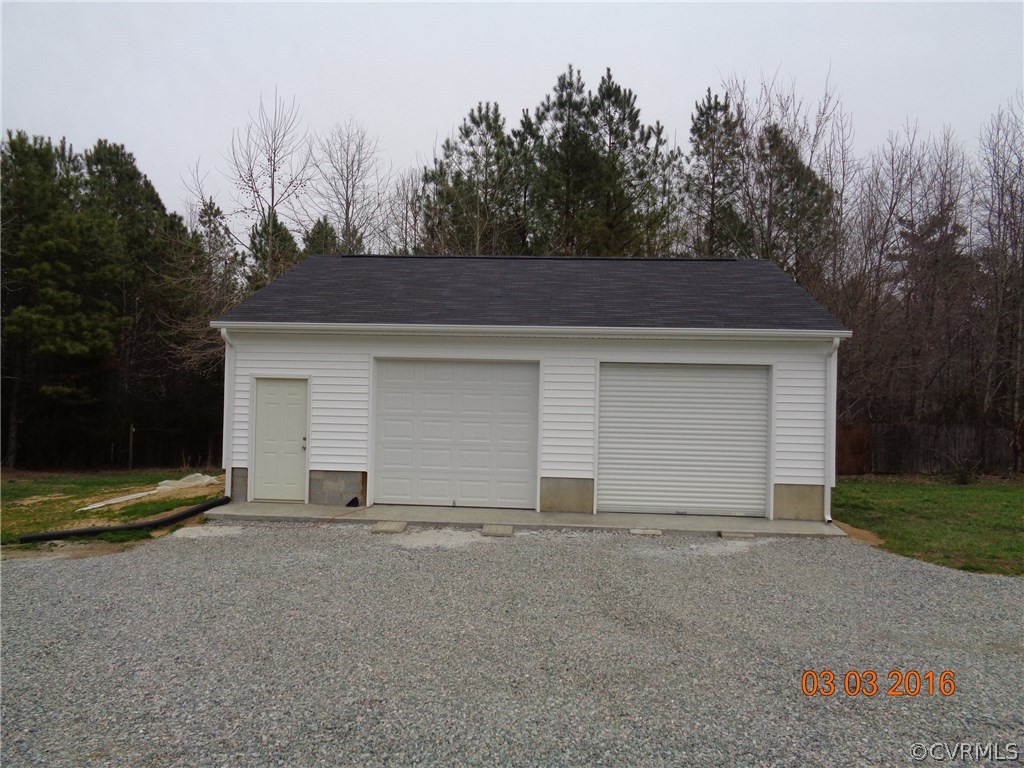 8612 Old Pine Road Ford, VA 23850 - Photo 8 of 27 a front view of a house with a yard and garage