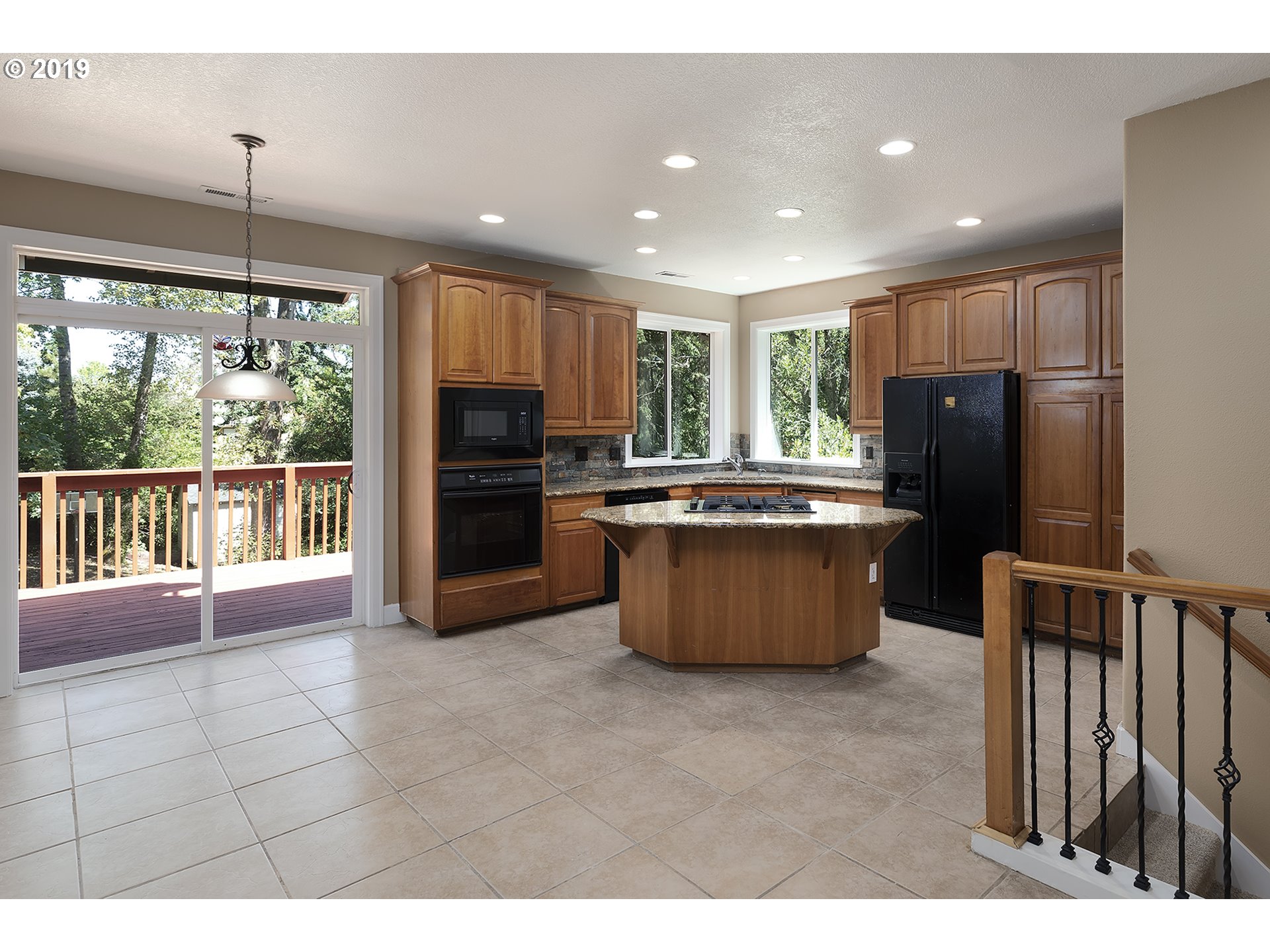 1925 Hillcrest Drive West Linn, OR 97068 - Photo 6 of 32 a kitchen with stainless steel appliances granite countertop a refrigerator a sink a stove top oven and a refrigerator