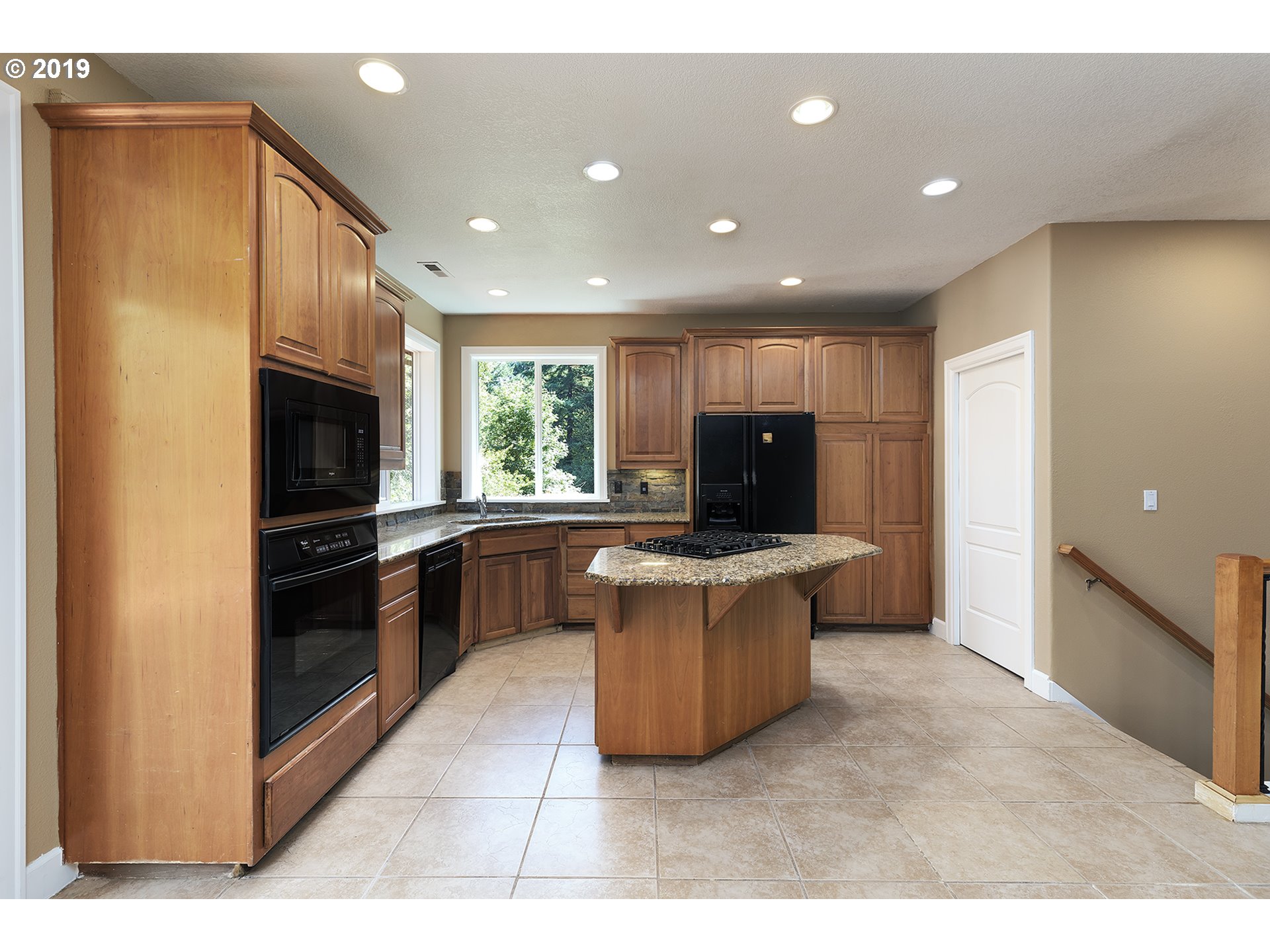 1925 Hillcrest Drive West Linn, OR 97068 - Photo 7 of 32 a kitchen with granite countertop a stove top oven and refrigerator